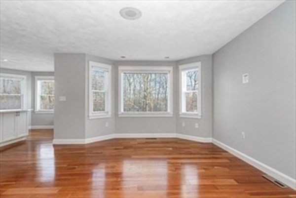 12 Hanson Lane Dracut, MA 01826 - Photo 8 of 23 a view of empty room with wooden floor and fan