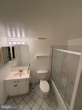 a bathroom with a sink mirror vanity and toilet