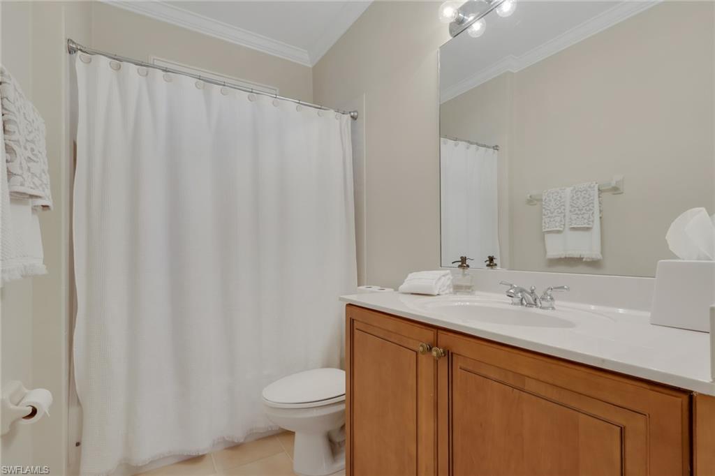 1859 Ivory Cane Point Naples, FL 34119 - Photo 26 of 50 Full bath with ornamental molding, a shower with curtain, vanity, and light tile patterned flooring