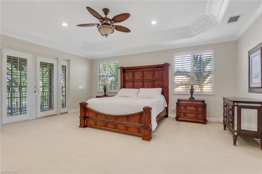 1859 Ivory Cane Point Naples, FL 34119 - Photo 27 of 50 Bedroom featuring light colored carpet, access to outside, crown molding, multiple windows, and ceiling fan