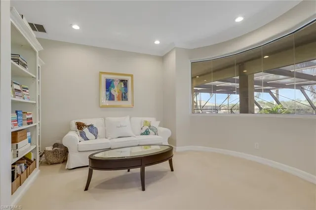 a spacious bedroom with a bed ceiling fan and a window