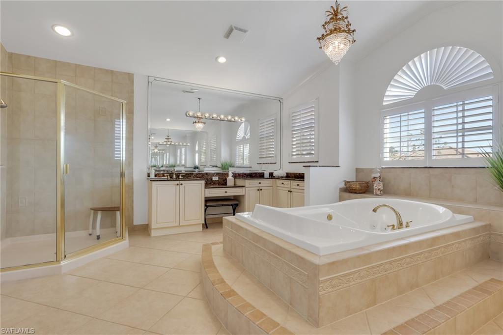 1859 Ivory Cane Point Naples, FL 34119 - Photo 32 of 50 Bathroom featuring vanity, a chandelier, a shower stall, a bath, and recessed lighting