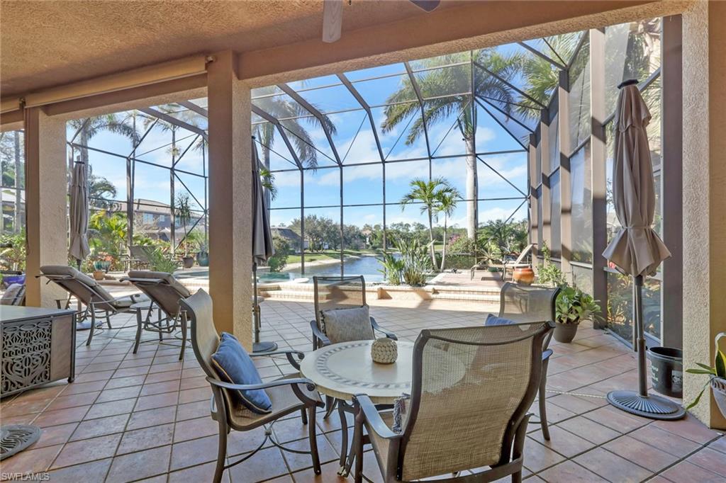 1859 Ivory Cane Point Naples, FL 34119 - Photo 37 of 50 View of patio / terrace featuring a sunroom, an outdoor pool, a lanai, and a ceiling fan