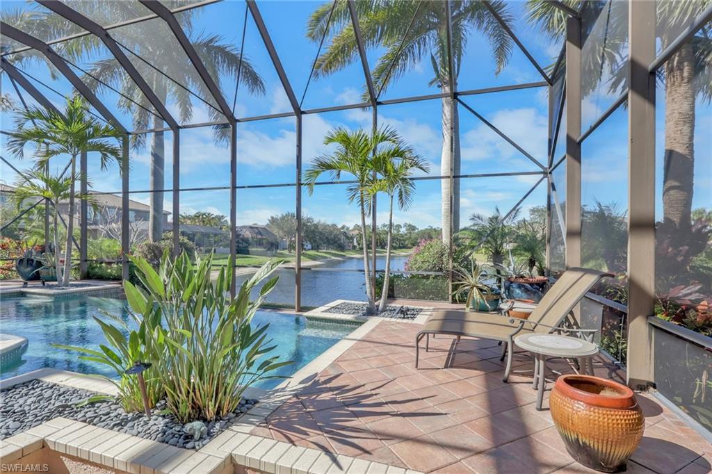 1859 Ivory Cane Point Naples, FL 34119 - Photo 39 of 50 View of swimming pool with a sunroom, a lanai, a water view, a patio, and a pool with connected hot tub