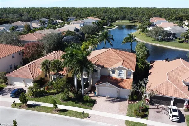 an aerial view of a house with garden space and lake view