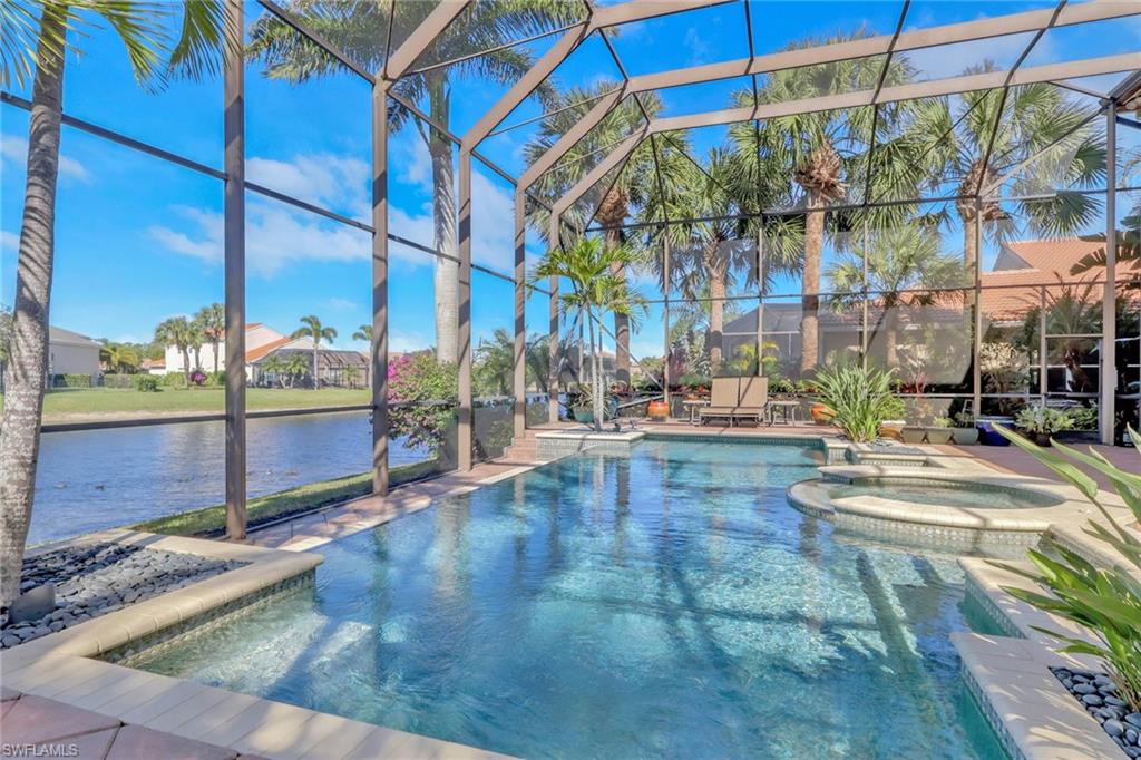 1859 Ivory Cane Point Naples, FL 34119 - Photo 41 of 50 View of swimming pool with a pool with connected hot tub, a patio area, a water view, glass enclosure, and a sunroom