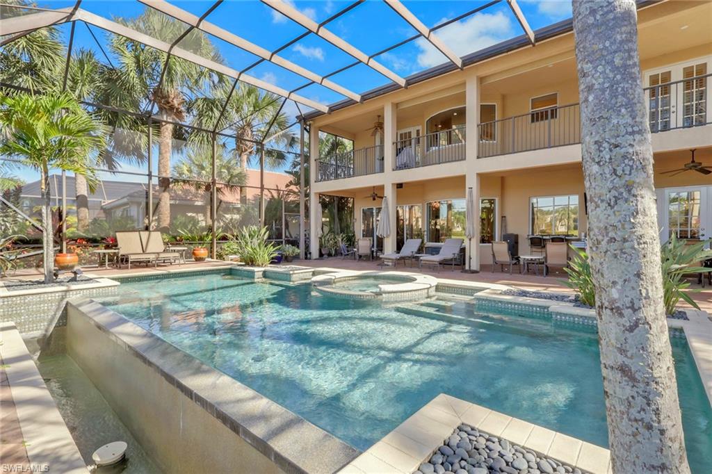 1859 Ivory Cane Point Naples, FL 34119 - Photo 42 of 50 View of pool featuring a patio area, glass enclosure, a pool with connected hot tub, and a balcony