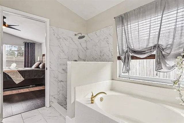 a bathroom with a bathtub and a window