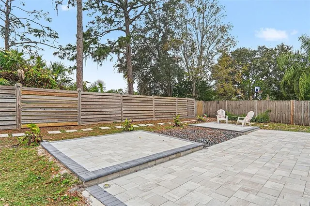 a view of a backyard with a tree