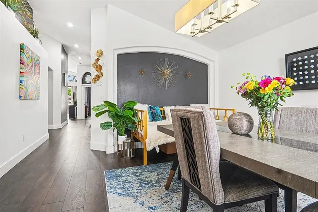 a dining room with furniture and flowers