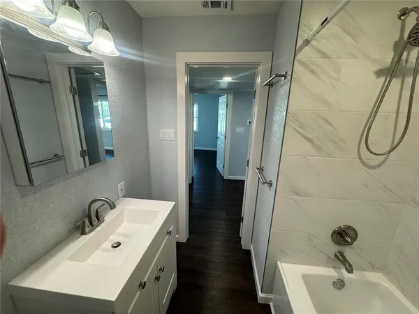 a bathroom with a double vanity sink and a mirror