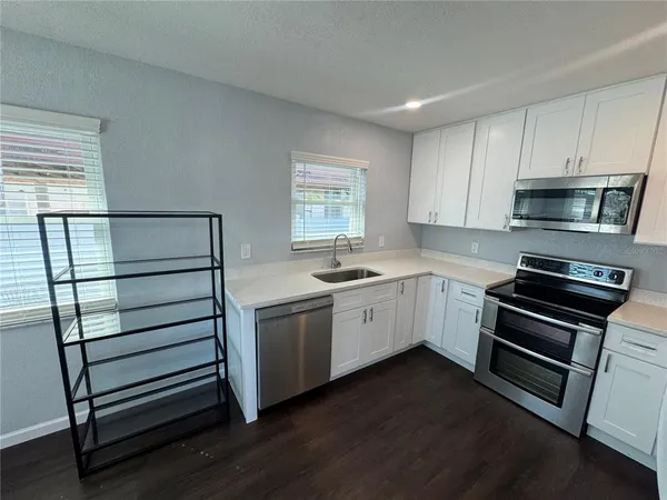 a kitchen with sink cabinets and stainless steel appliances