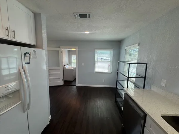 a view of hallway with furniture and wooden floor