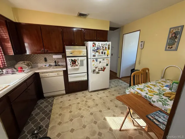 a kitchen with stainless steel appliances a stove a refrigerator and a sink
