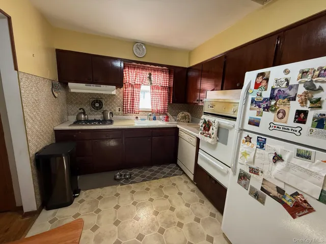 a kitchen with a sink appliances and cabinets