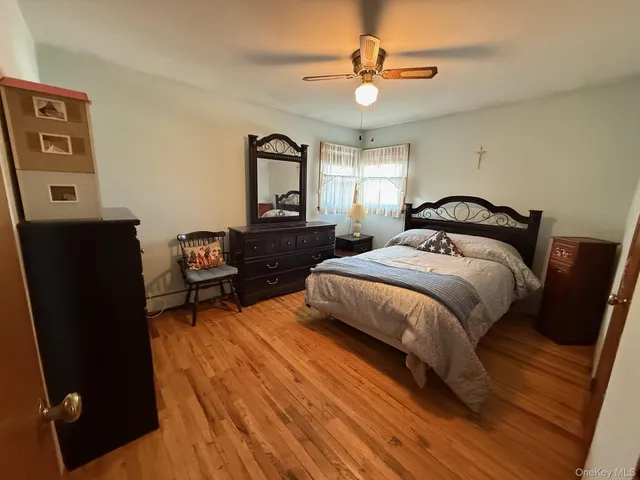 a spacious bedroom with a bed and a chandelier