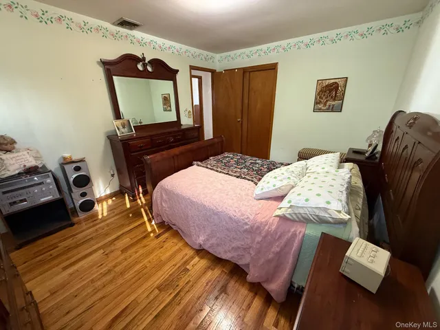 a bedroom with a bed and a television