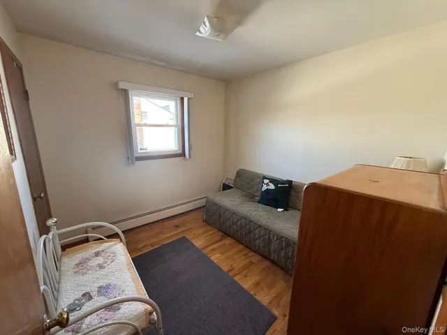 a bed sitting in a bedroom next to a window