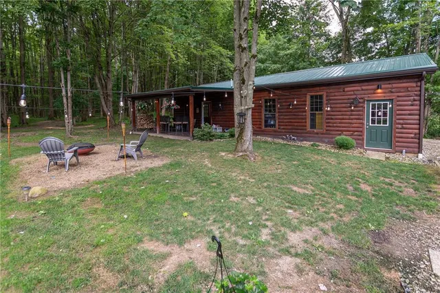a view of a house with backyard sitting area and garden