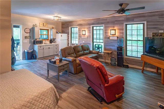 a living room with furniture fireplace and a large window