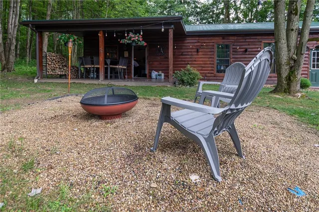 a view of a backyard with table and chairs and wooden fence