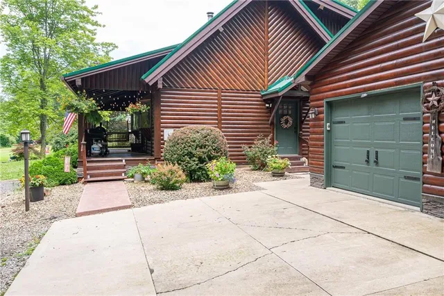 a backyard of a house with potted plants and a fountain