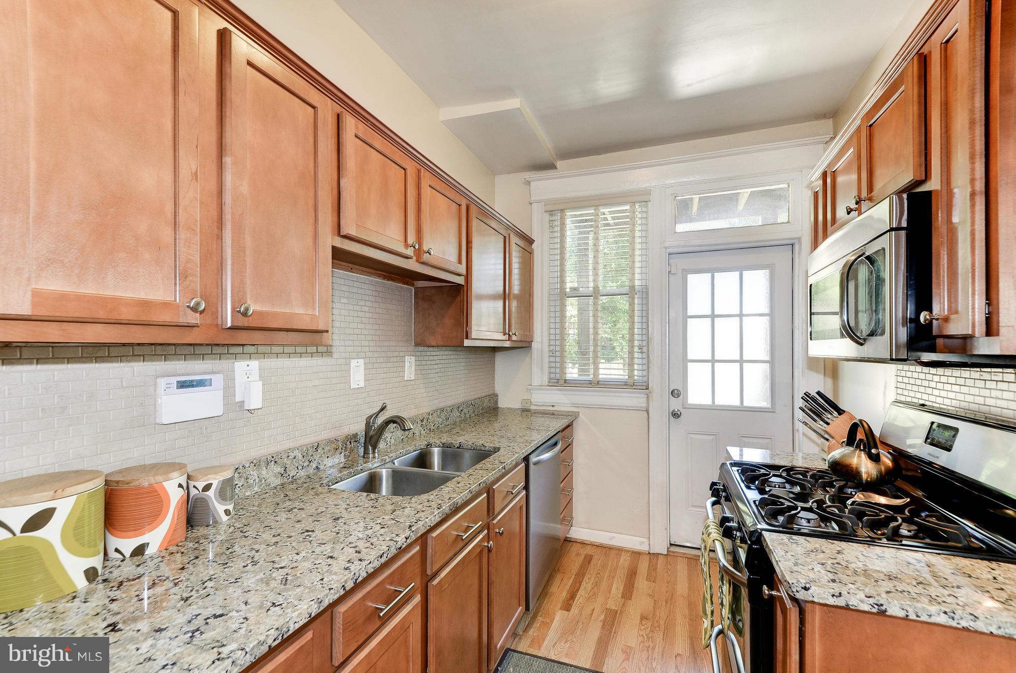 809 Jefferson Street Northwest Washington, DC 20011 - Photo 11 of 26 a kitchen with stainless steel appliances granite countertop a sink stove and cabinets