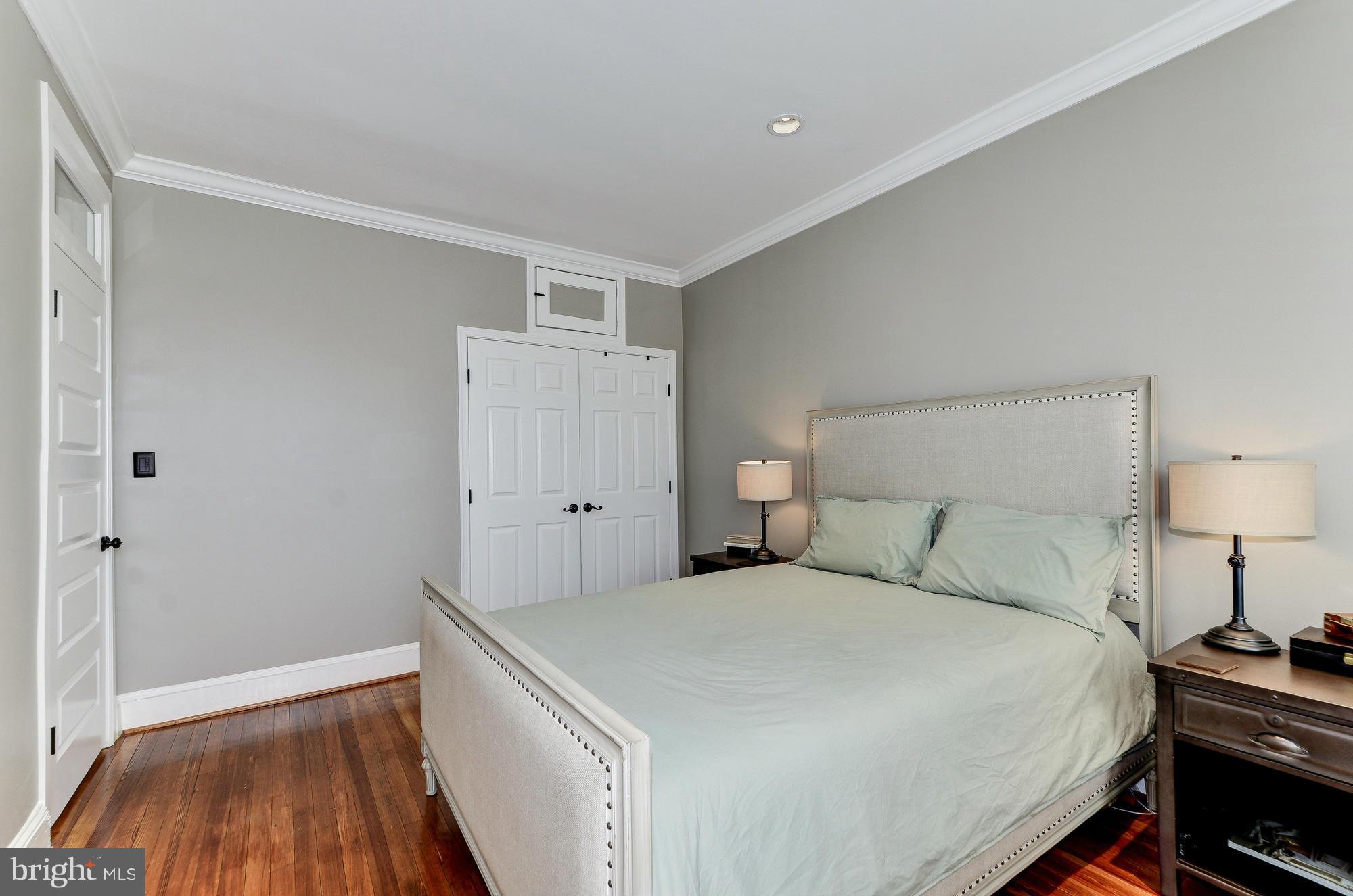 809 Jefferson Street Northwest Washington, DC 20011 - Photo 15 of 26 a bedroom with a bed and wooden floor