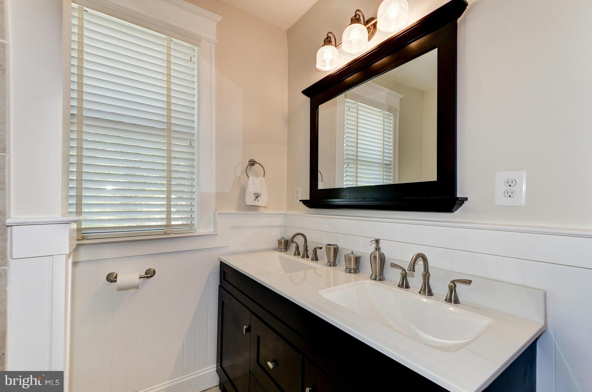 809 Jefferson Street Northwest Washington, DC 20011 - Photo 16 of 26 a bathroom with a sink vanity and a mirror