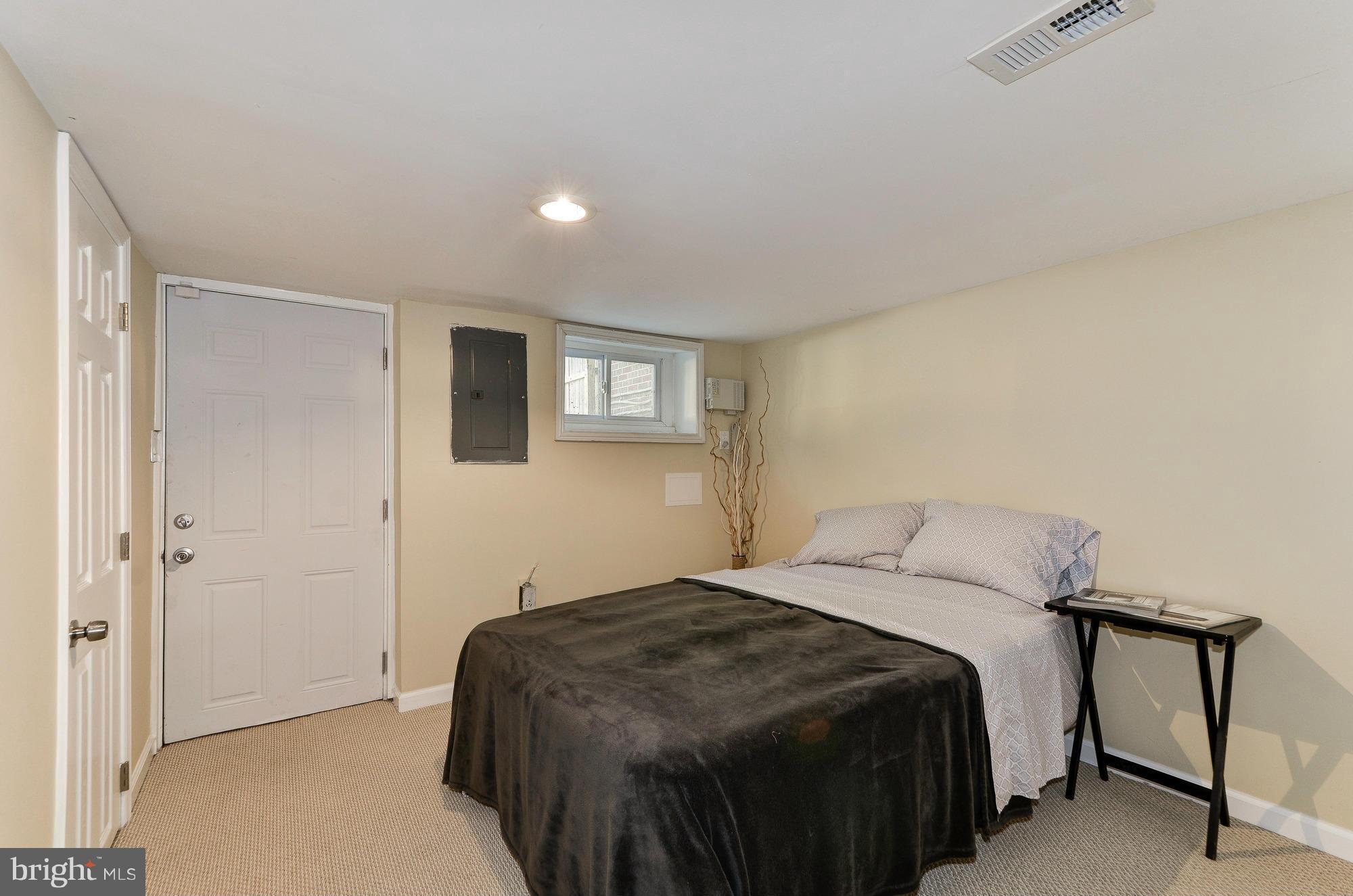 809 Jefferson Street Northwest Washington, DC 20011 - Photo 21 of 26 a bedroom with a bed and a window