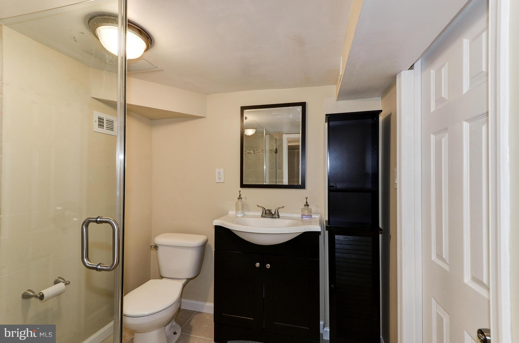 809 Jefferson Street Northwest Washington, DC 20011 - Photo 22 of 26 a bathroom with a toilet sink and mirror