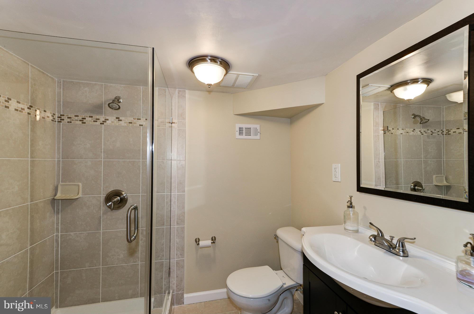 809 Jefferson Street Northwest Washington, DC 20011 - Photo 23 of 26 a bathroom with a sink toilet and shower