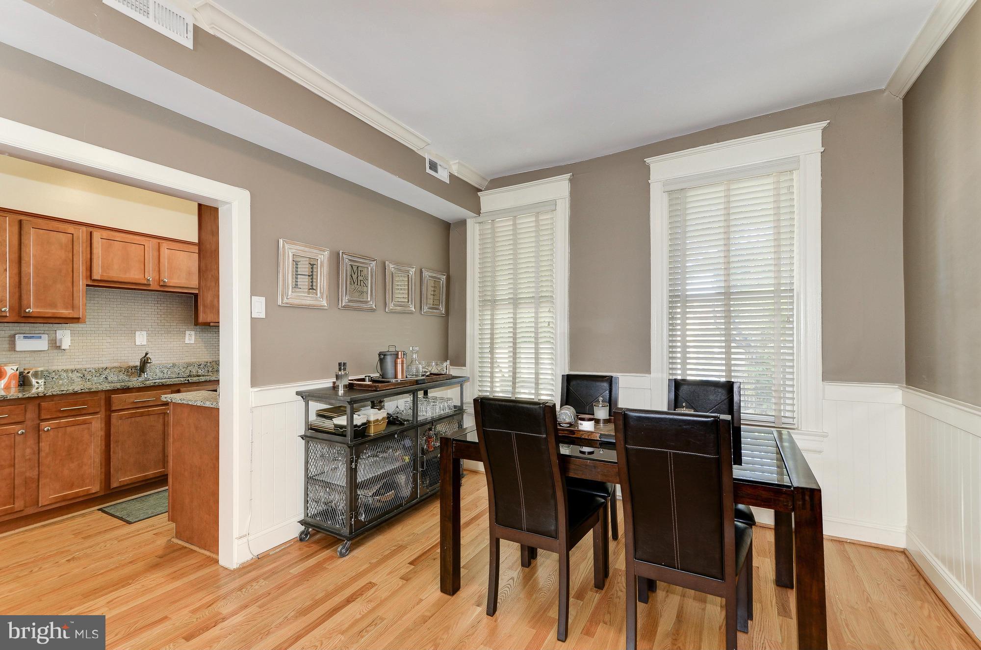 809 Jefferson Street Northwest Washington, DC 20011 - Photo 10 of 26 a kitchen with a table chairs stove and microwave