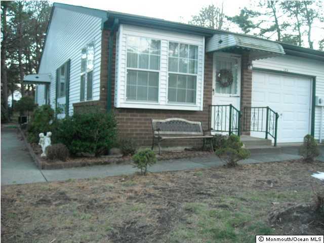 18A Sunset Road, Unit A Whiting, NJ 08759 - Photo 1 of 3 a front view of a house with a yard