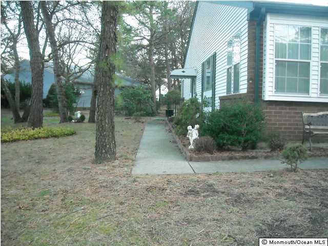 18A Sunset Road, Unit A Whiting, NJ 08759 - Photo 2 of 3 a backyard of a house with lots of green space