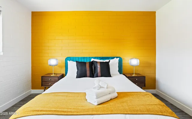 a bed sitting in a bedroom next to a blue wall