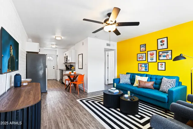 a living room with furniture and kitchen view