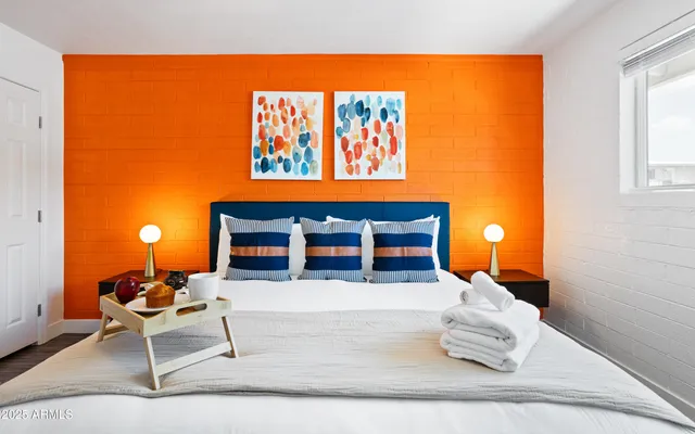 a living room with furniture a rug and a wall painting