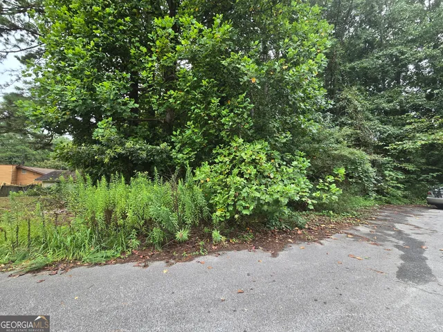 a backyard of a house with a yard and outdoor seating
