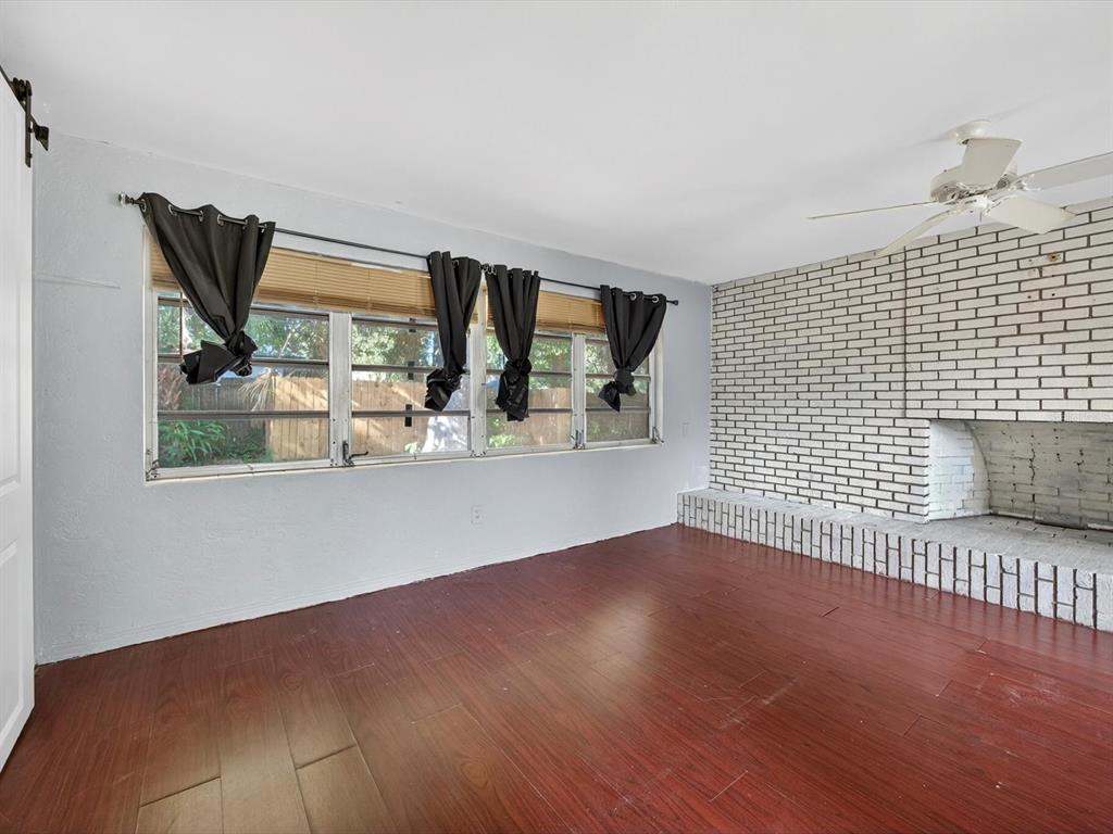 1068 Peter Road Daytona Beach, FL 32114 - Photo 12 of 37 a view of empty room with wooden floor and fan