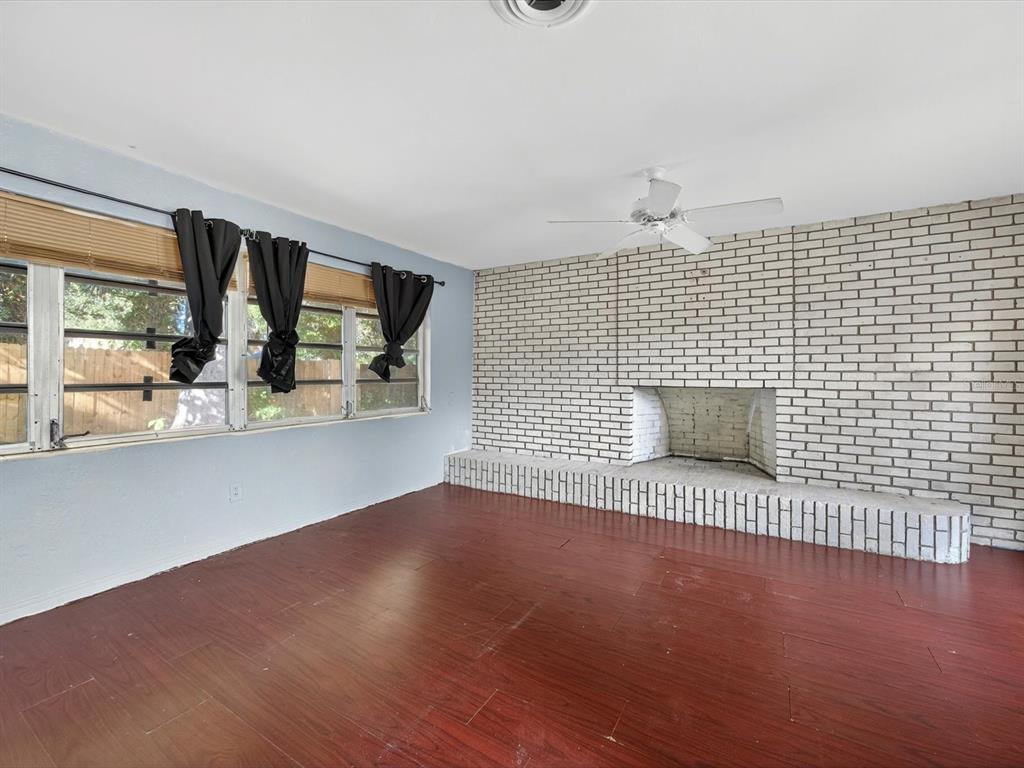 1068 Peter Road Daytona Beach, FL 32114 - Photo 13 of 37 an empty room with wooden floor and windows