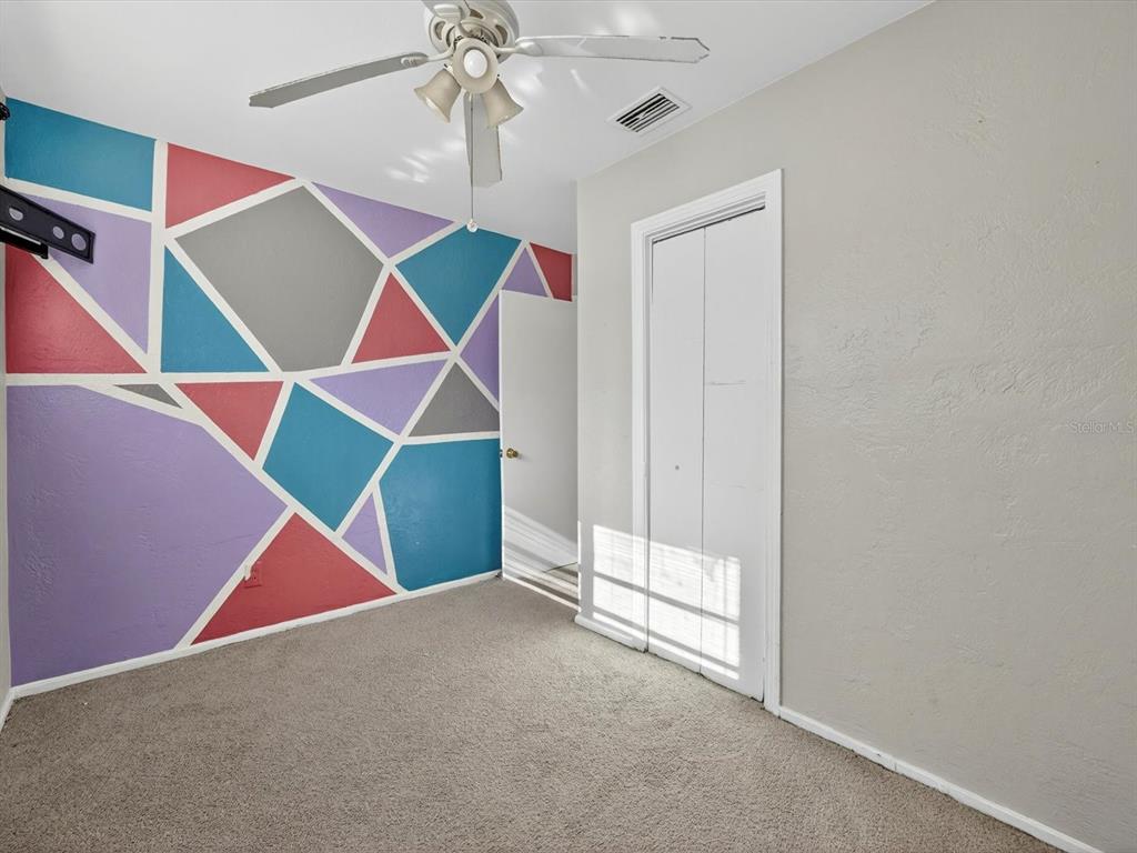 1068 Peter Road Daytona Beach, FL 32114 - Photo 17 of 37 a room that has a ceiling fan and a floor