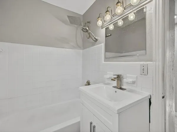 a bathroom with a sink a mirror and a shower
