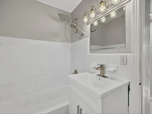 a bathroom with a sink a mirror and a shower