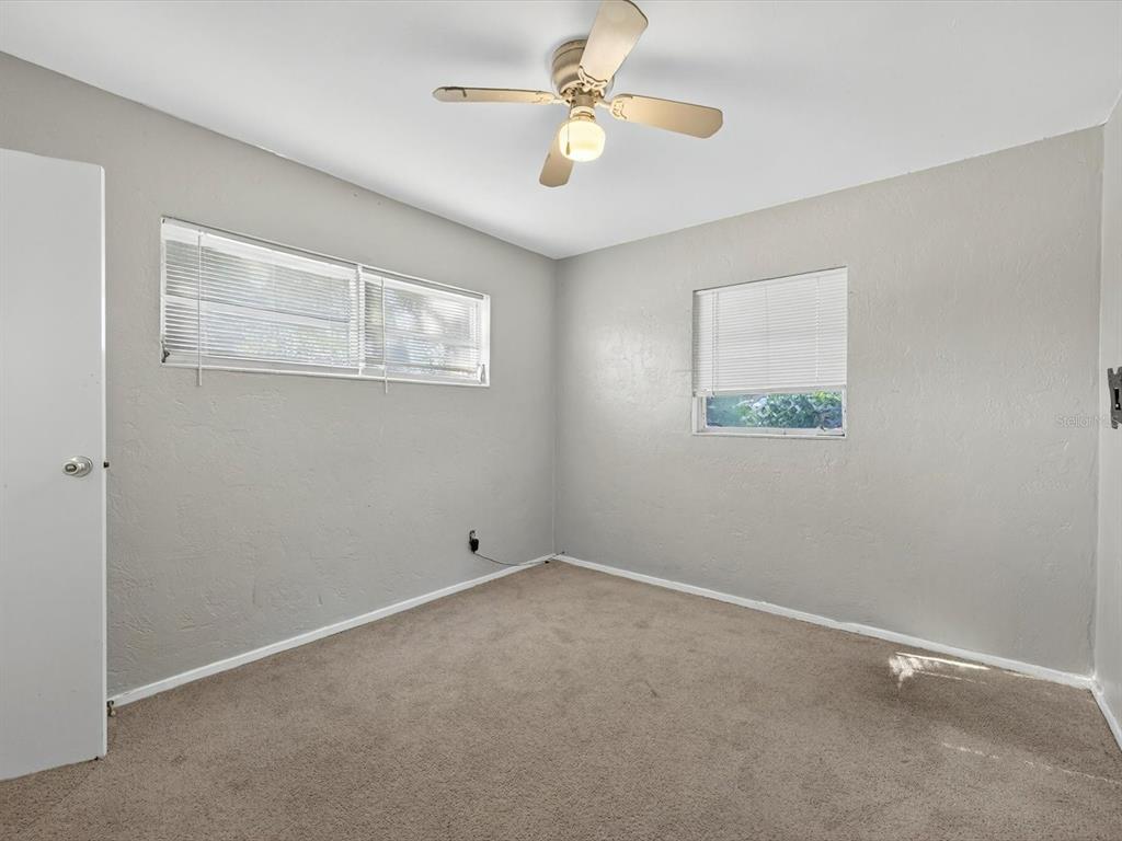 1068 Peter Road Daytona Beach, FL 32114 - Photo 20 of 37 an empty room with a window and a fan