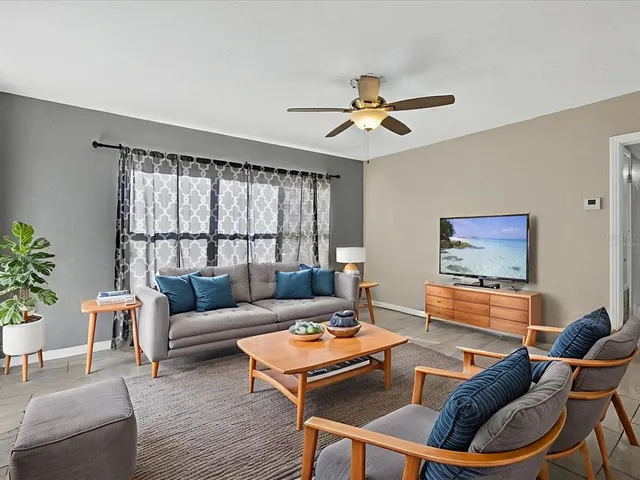 a living room with furniture and a large window