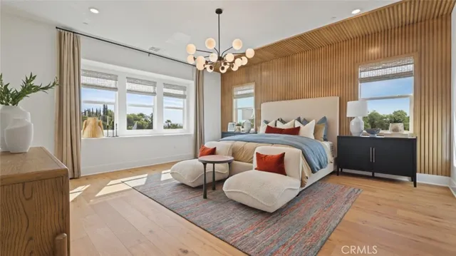 a bedroom with furniture and a large window