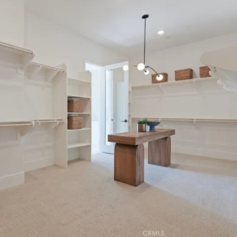 a kitchen with kitchen island a sink stainless steel appliances and cabinets