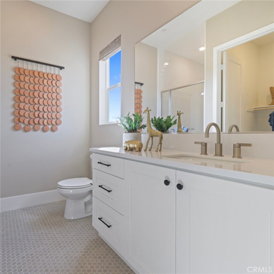 21381 Cloud Ridge Yorba Linda, CA 92887 - Photo 28 of 38 a bathroom with a toilet a sink and mirror