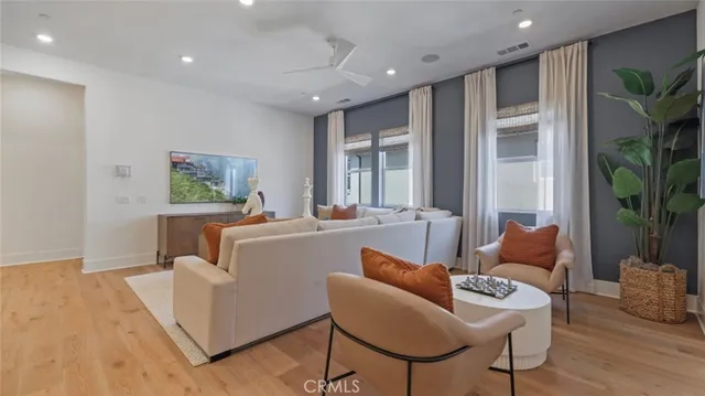 a living room with furniture and a potted plant